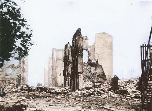 The corner and part of the facade of a brick building are among the only structures remaining on a street decimated by fighting during the Spanish Civil War. 